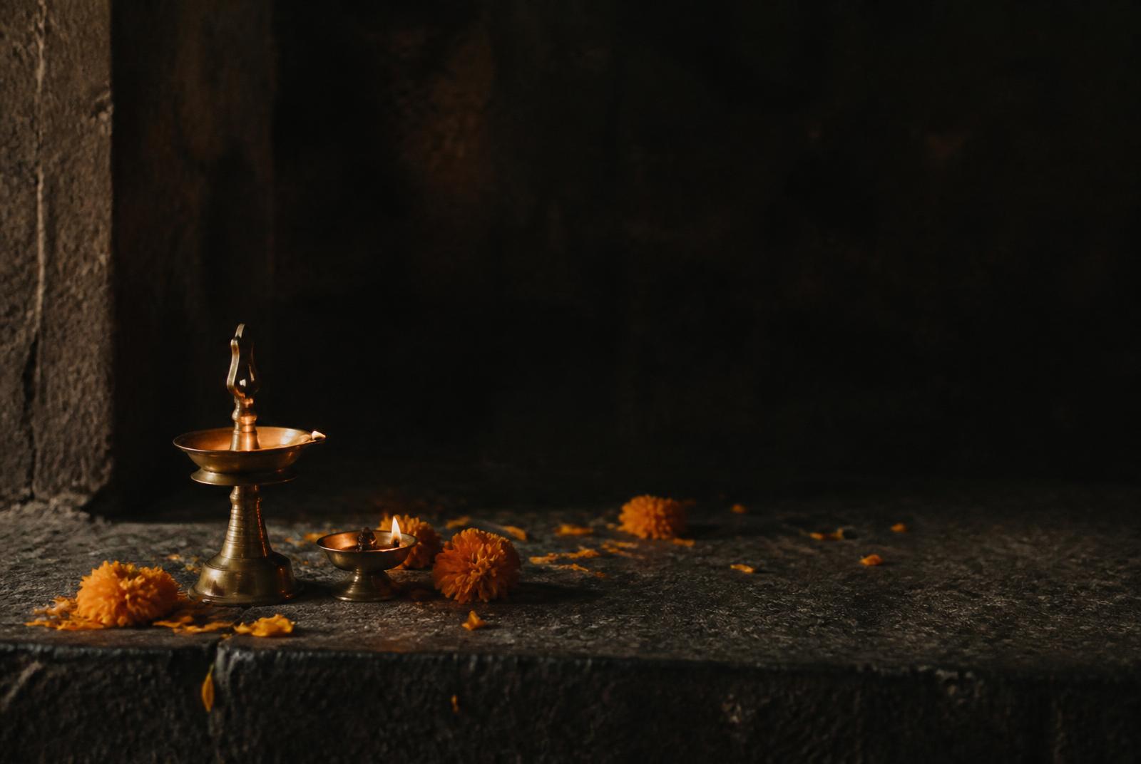Brass lamps and marigold petals